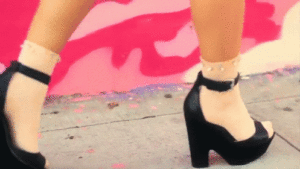 Confident woman walking in heels, showcasing the benefits of walking daily for self-care, wellness, and a healthy lifestyle.