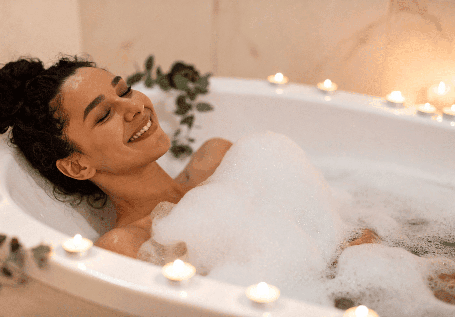 Woman relaxing in a bathtub showcasing small bathroom ideas.