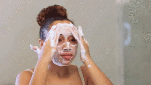 Woman doing her daily skincare routine as part of mindful self care for better mental health.