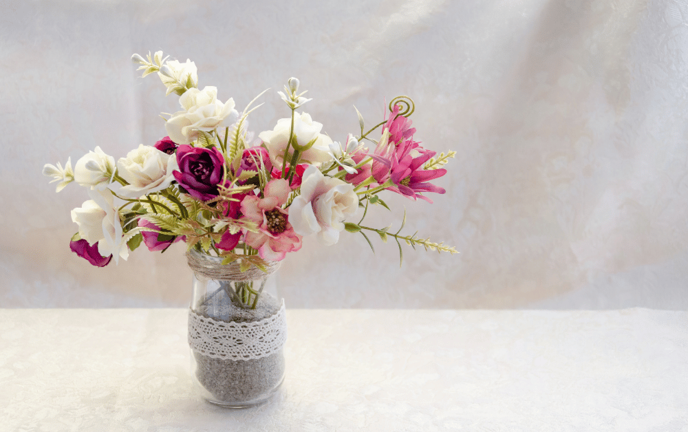 A calming arrangement of flowers in a vase symbolizing peace, self-care, and the connection between flowers and mental health.