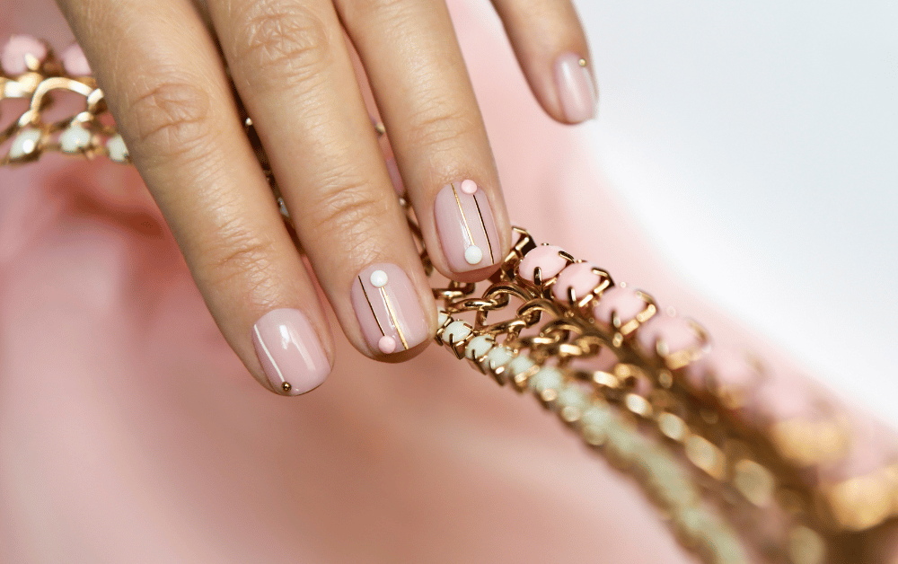Beautiful hand with a fresh manicure showcasing a trendy pattern from a nail polish set, perfect for at-home nail care and style inspiration.