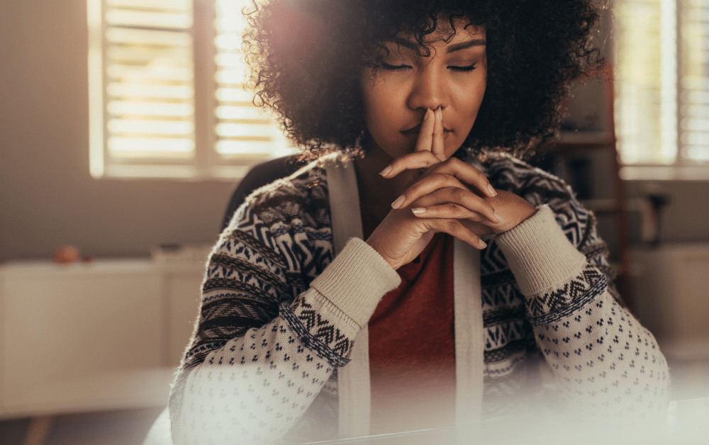 How to Be More Mindful. Lady sitting indoors and thinking quietly.