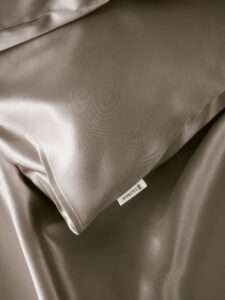 Lily Silk pillowcases displayed neatly, showcasing their smooth, luxurious texture—ideal self care products for enhancing sleep quality and skincare.