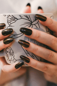 Dark-colored acrylic New Year’s nails with a bold and elegant finish.