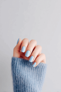 Close-up of blue nails with a sleek glossy finish and cool-toned shade, creating a bold yet elegant manicure ideal for trendy New Year’s nails.