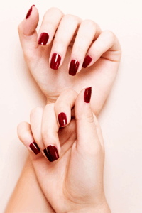 Close-up of burgundy nails with a rich, deep-toned glossy finish, styled in an elegant and sophisticated manicure perfect for chic New Year’s nails.