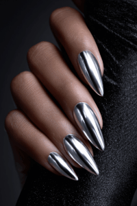Close-up of elegant silver nails with a high-shine metallic finish and subtle sparkle, styled for a festive manicure look perfect for glamorous New Year’s nails.