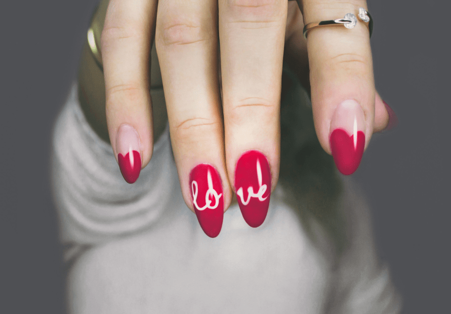A woman with a nail design for valentines day nails.
