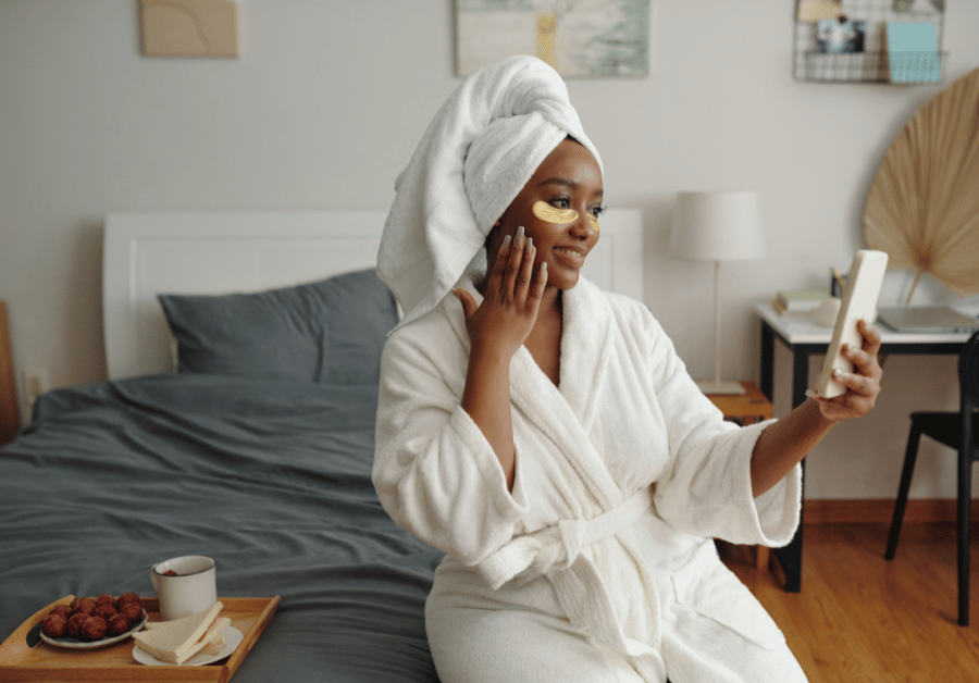 Woman in a white robe enjoying a self-care Sunday routine at home with a calm self-care aesthetic.