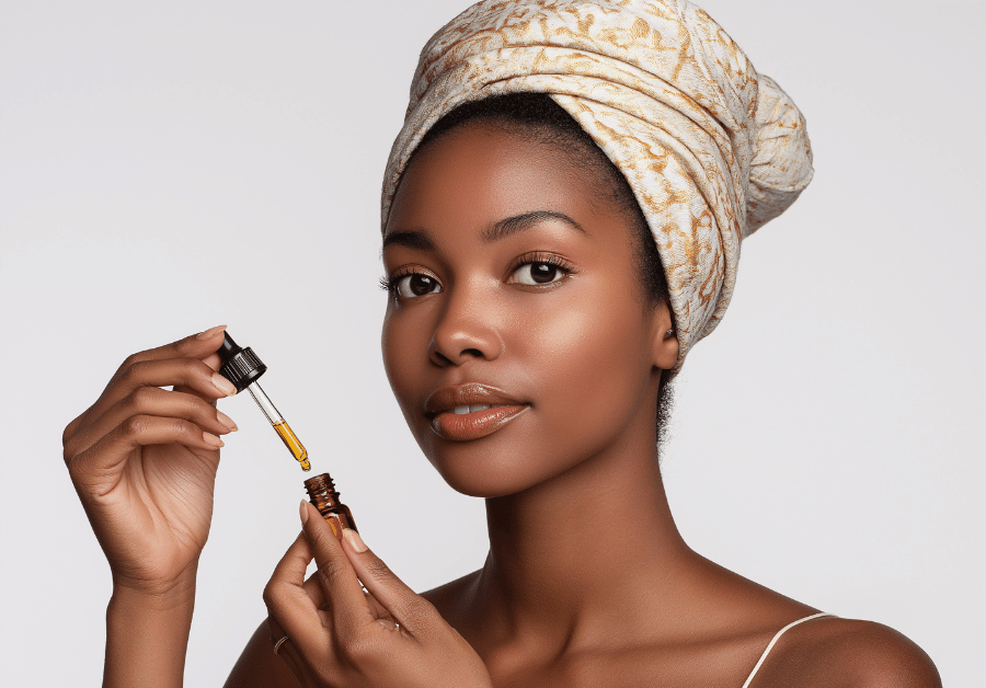 Woman applying a serum as part of her beauty self-care routine for glowing skin.